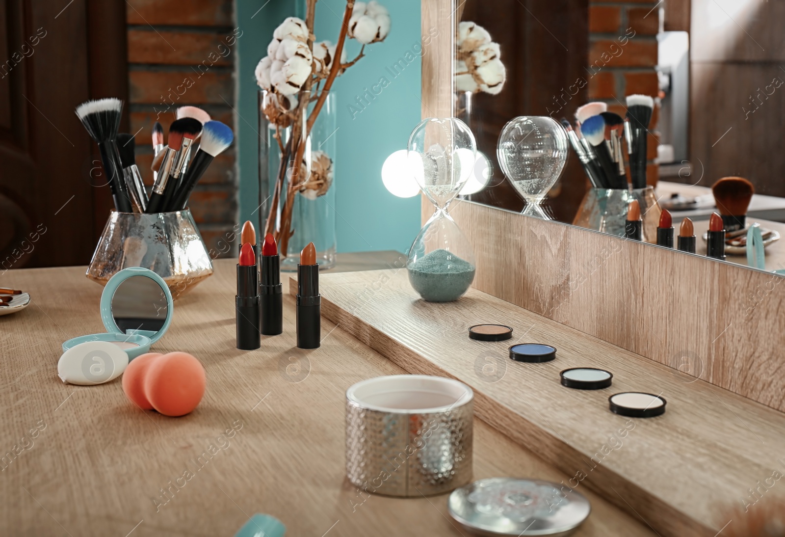 Photo of Decorative cosmetics and tools on dressing table in makeup room, closeup