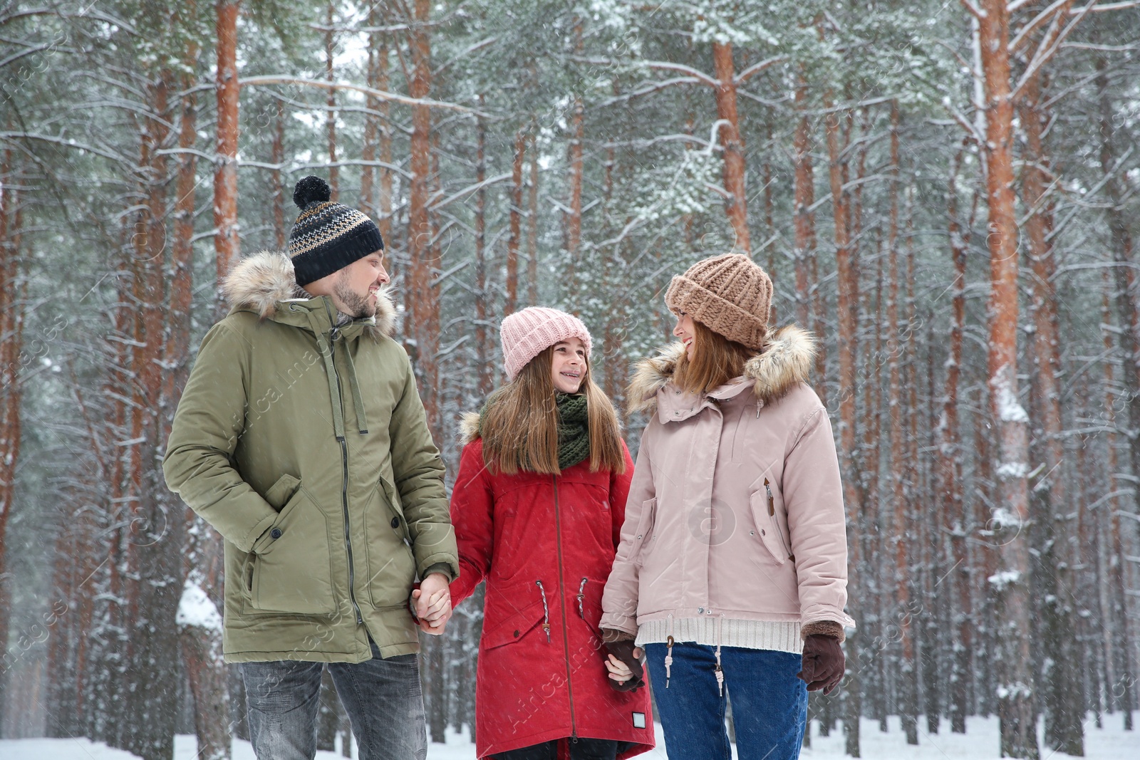 Photo of Happy family in forest on snow day