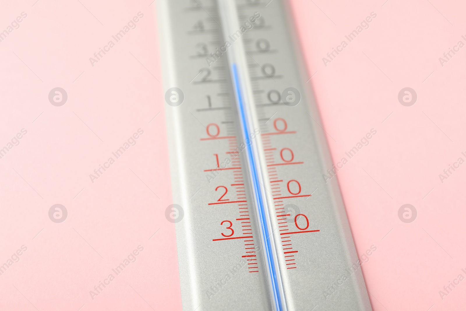 Photo of Modern weather thermometer on pink background, closeup