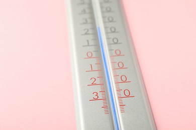 Modern weather thermometer on pink background, closeup