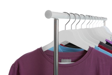 Men clothes hanging on wardrobe rack against white background, closeup