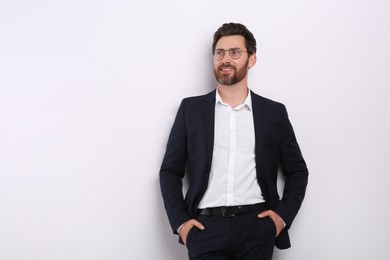 Portrait of handsome man in glasses on white background, space for text