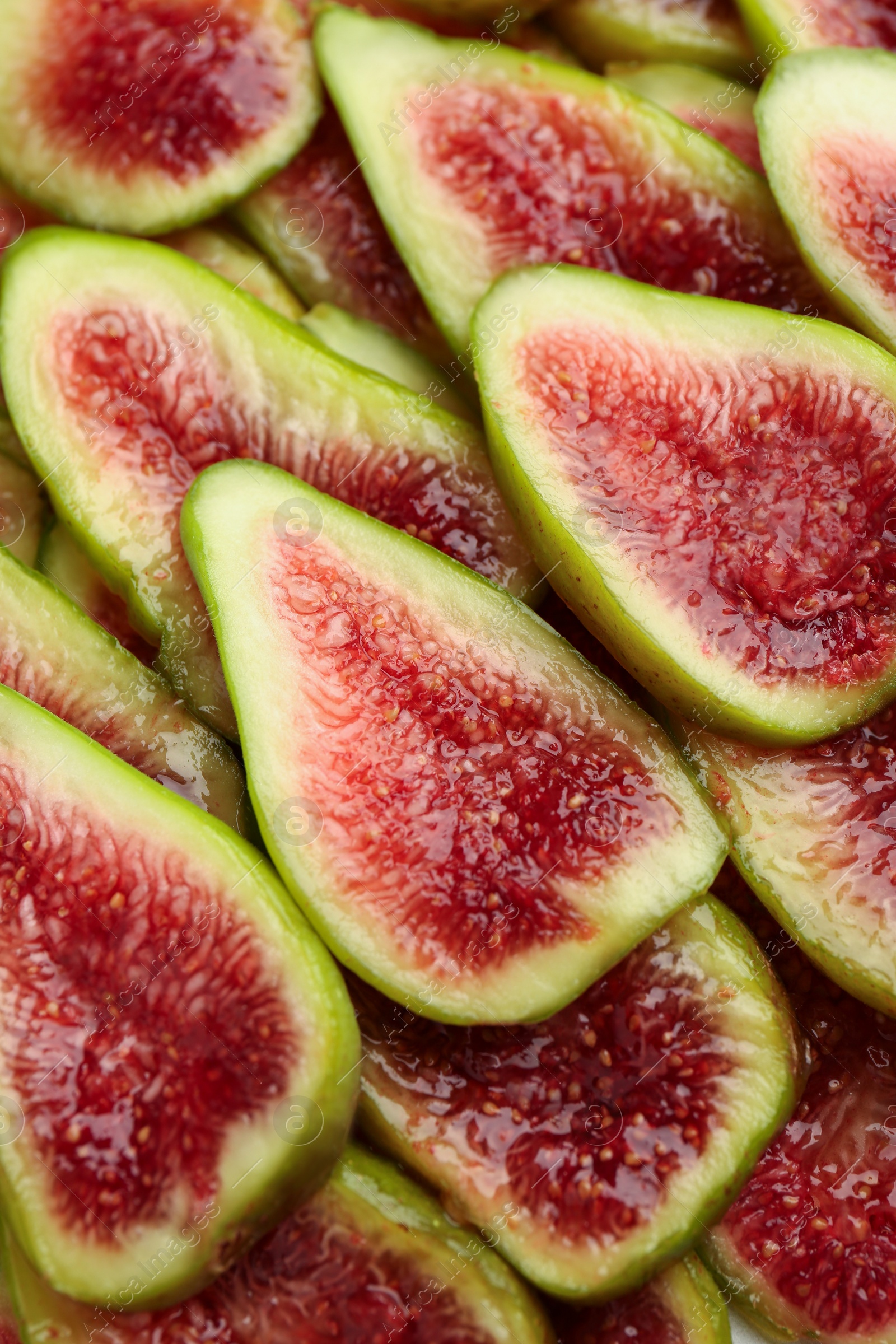 Photo of Pieces of fresh green figs as background, top view