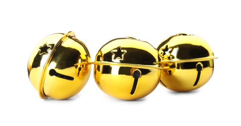 Photo of Shiny golden sleigh bells on white background