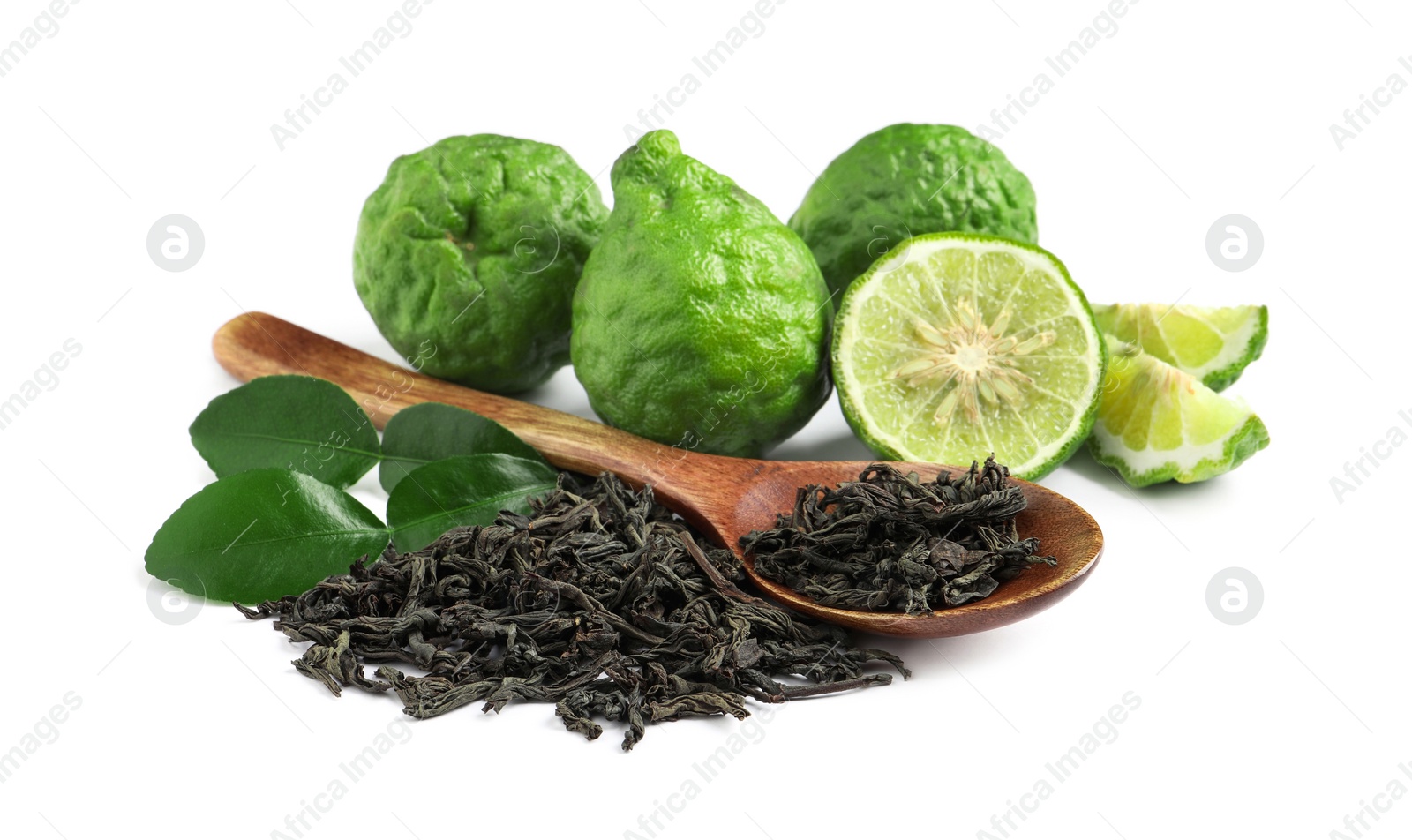 Photo of Dry bergamot tea leaves, wooden spoon and fresh fruits on white background