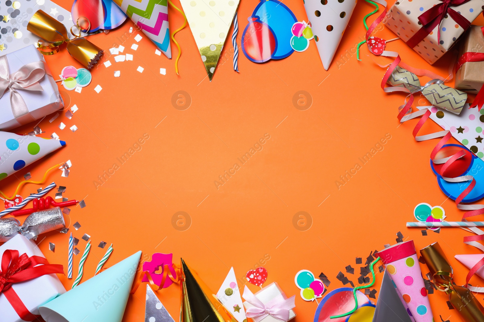 Photo of Frame of party items on orange background, flat lay. Space for text