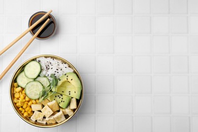 Photo of Delicious poke bowl with vegetables, tofu, avocado and microgreens served on white tiled table, flat lay. Space for text