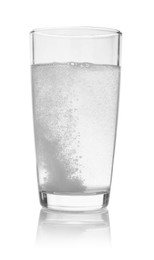 Photo of Effervescent pill dissolving in glass of water isolated on white