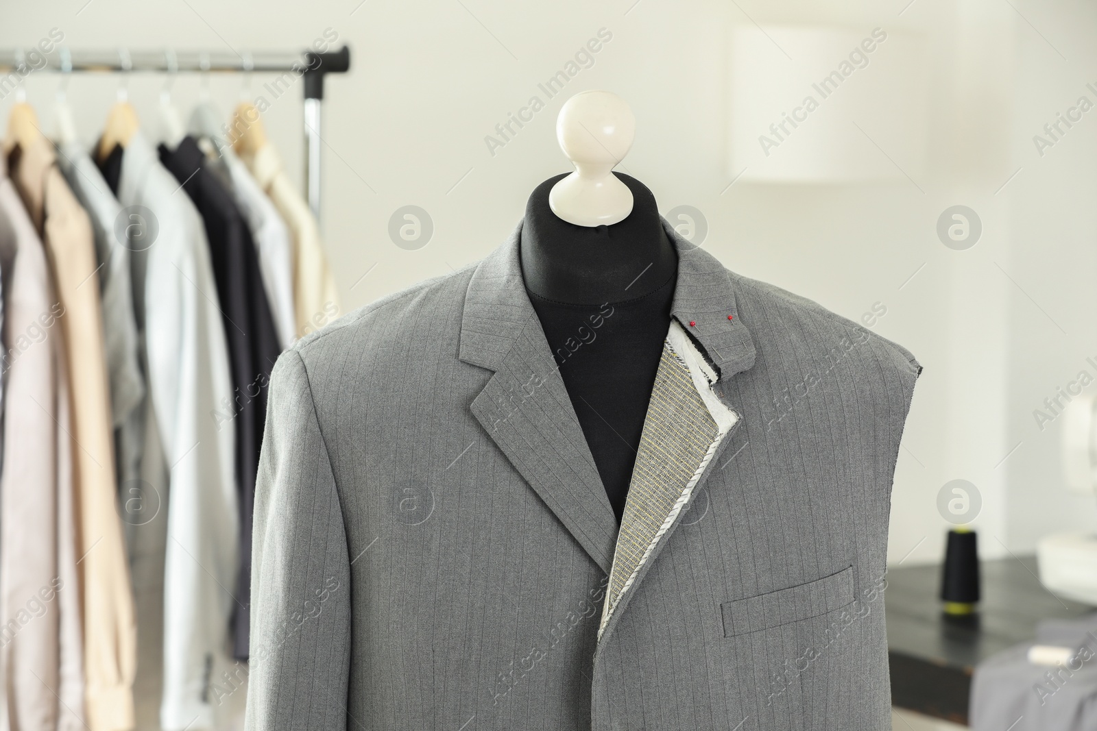 Photo of Mannequin with unfinished jacket in tailor shop