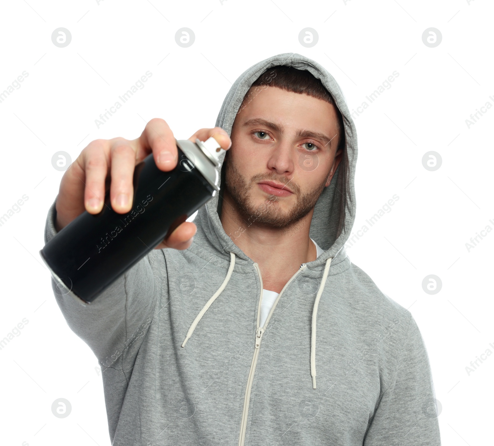 Photo of Handsome man holding can of black spray paint against white background