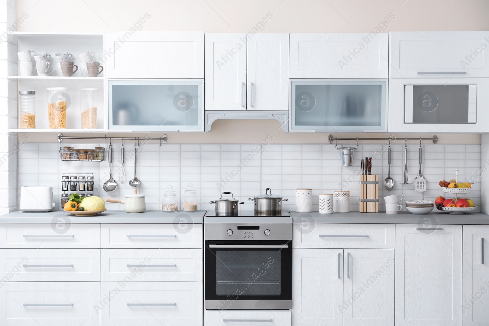 Photo of Modern kitchen interior with houseware and new furniture