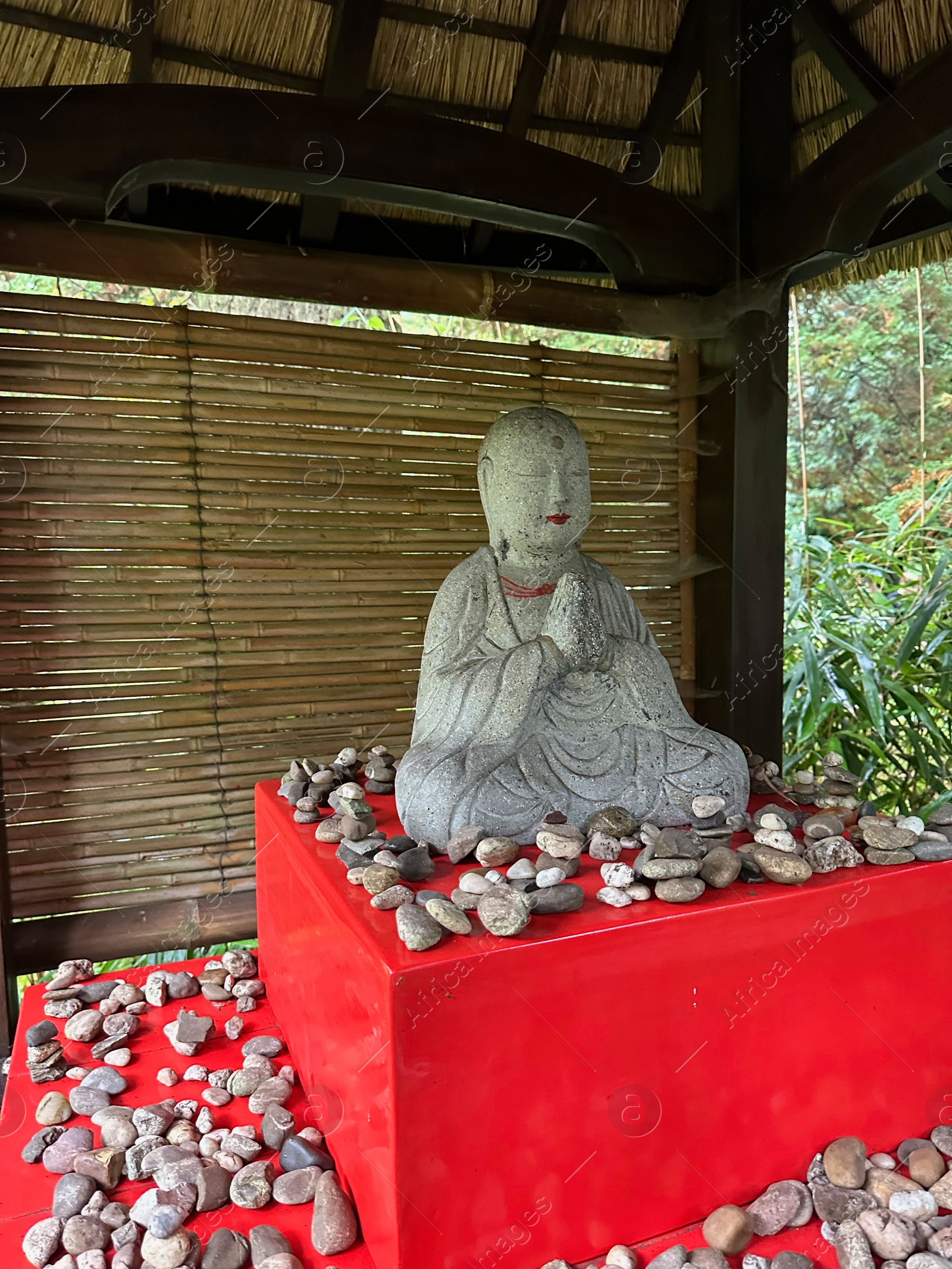 Photo of Beautiful Buddha statue and lots of stones in Japanese garden