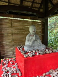 Photo of Beautiful Buddha statue and lots of stones in Japanese garden