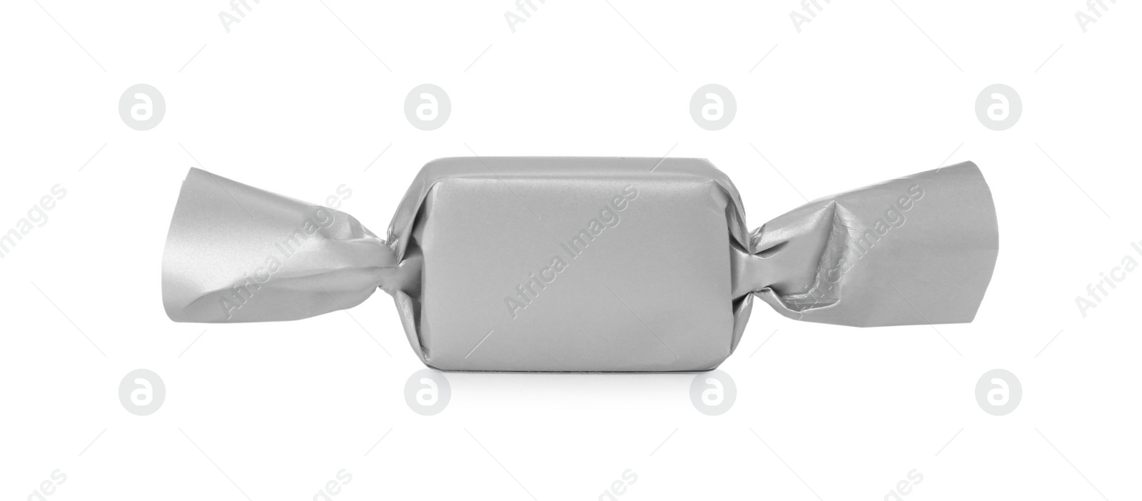 Photo of Delicious candy in silver wrapper isolated on white