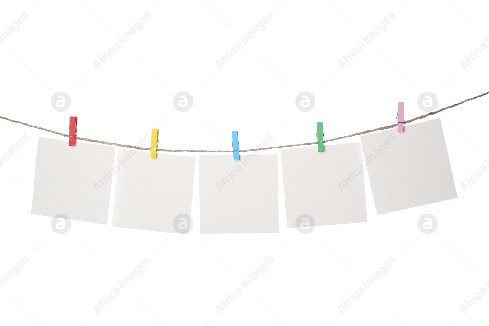 Photo of Clothespins with empty notepapers on string against white background. Space for text