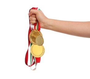 Woman holding gold medals on white background, closeup