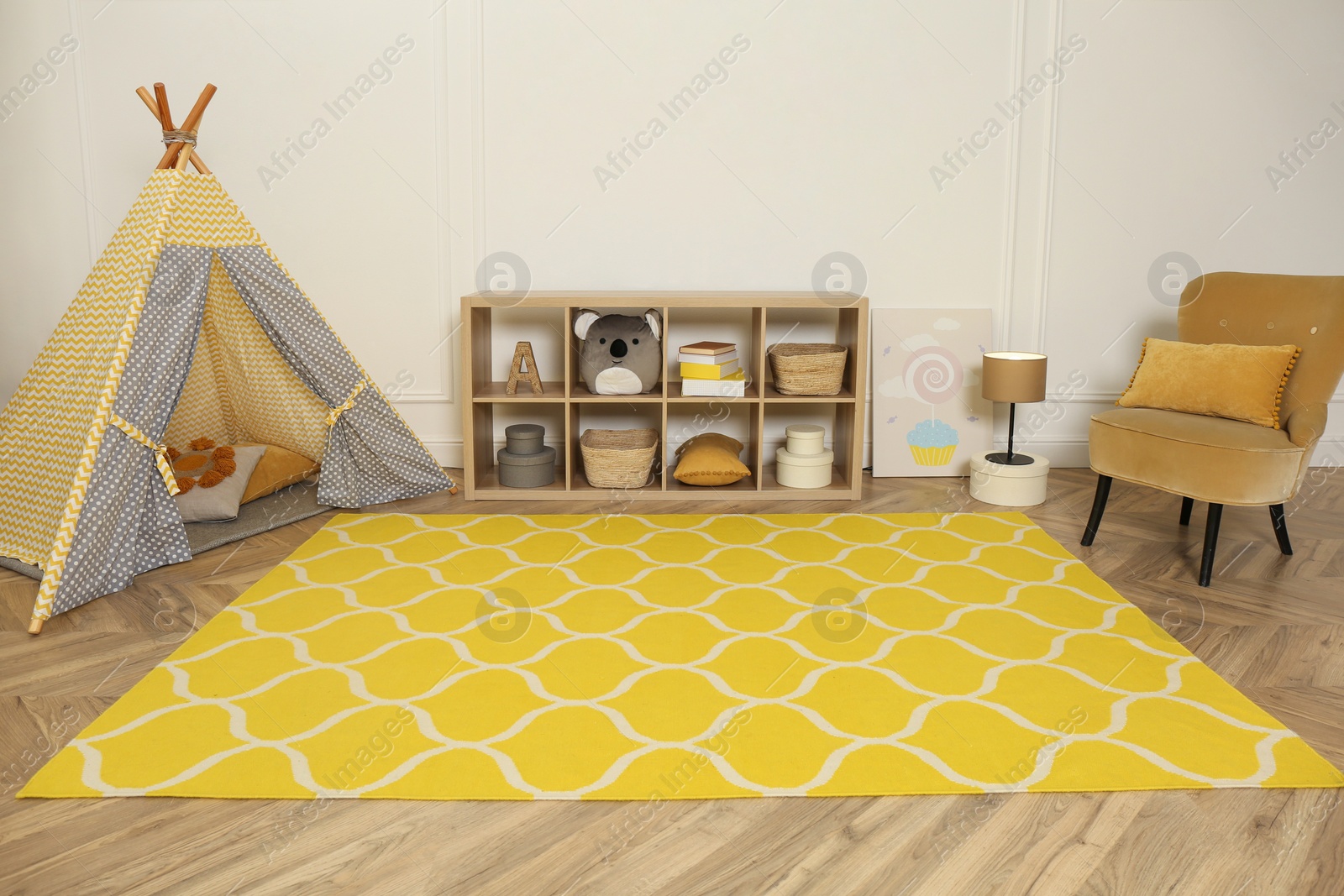 Photo of Modern children's room interior with yellow carpet and stylish furniture