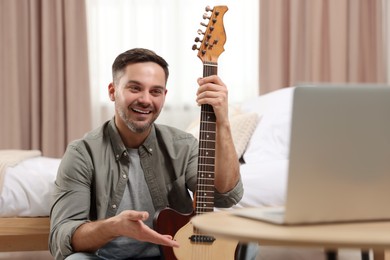 Photo of Music teacher talking with students while conducting online lesson at home. Time for hobby