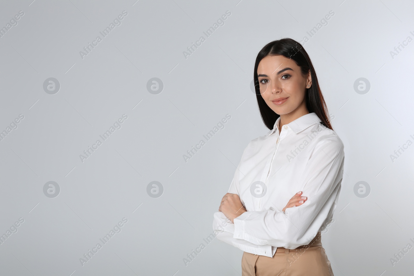 Photo of Portrait of young businesswoman on white background. Space for text