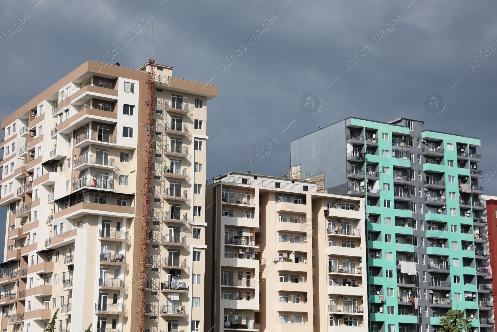 Photo of Beautiful view of multi storey apartment buildings under gloomy sky