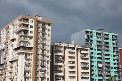 Beautiful view of multi storey apartment buildings under gloomy sky