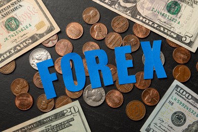 Photo of Word Forex made of blue letters with coins and banknotes on black table, flat lay
