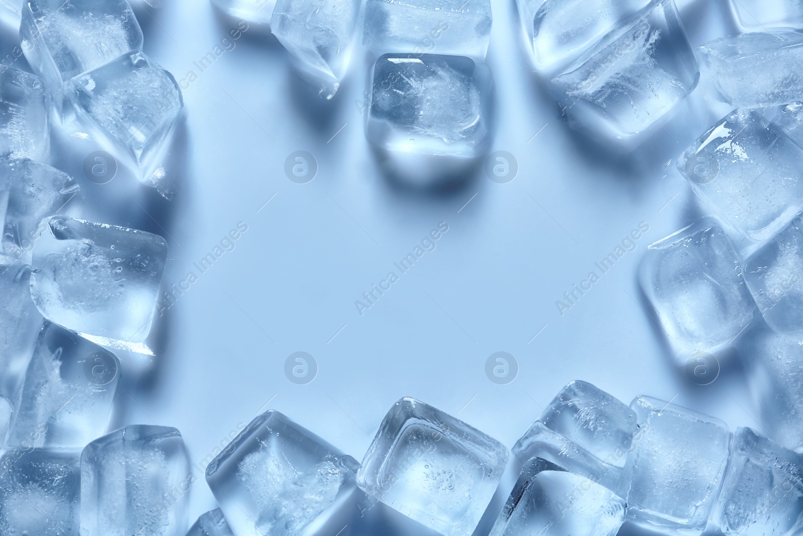 Photo of Frame made of ice cubes on color background, top view. Space for text