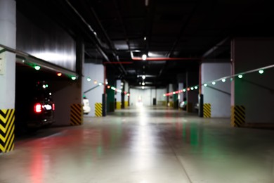 Photo of Blurred view of modern car parking garage