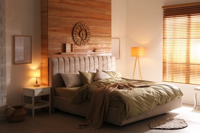 Photo of Comfortable bed with new pistachio linens in modern room interior