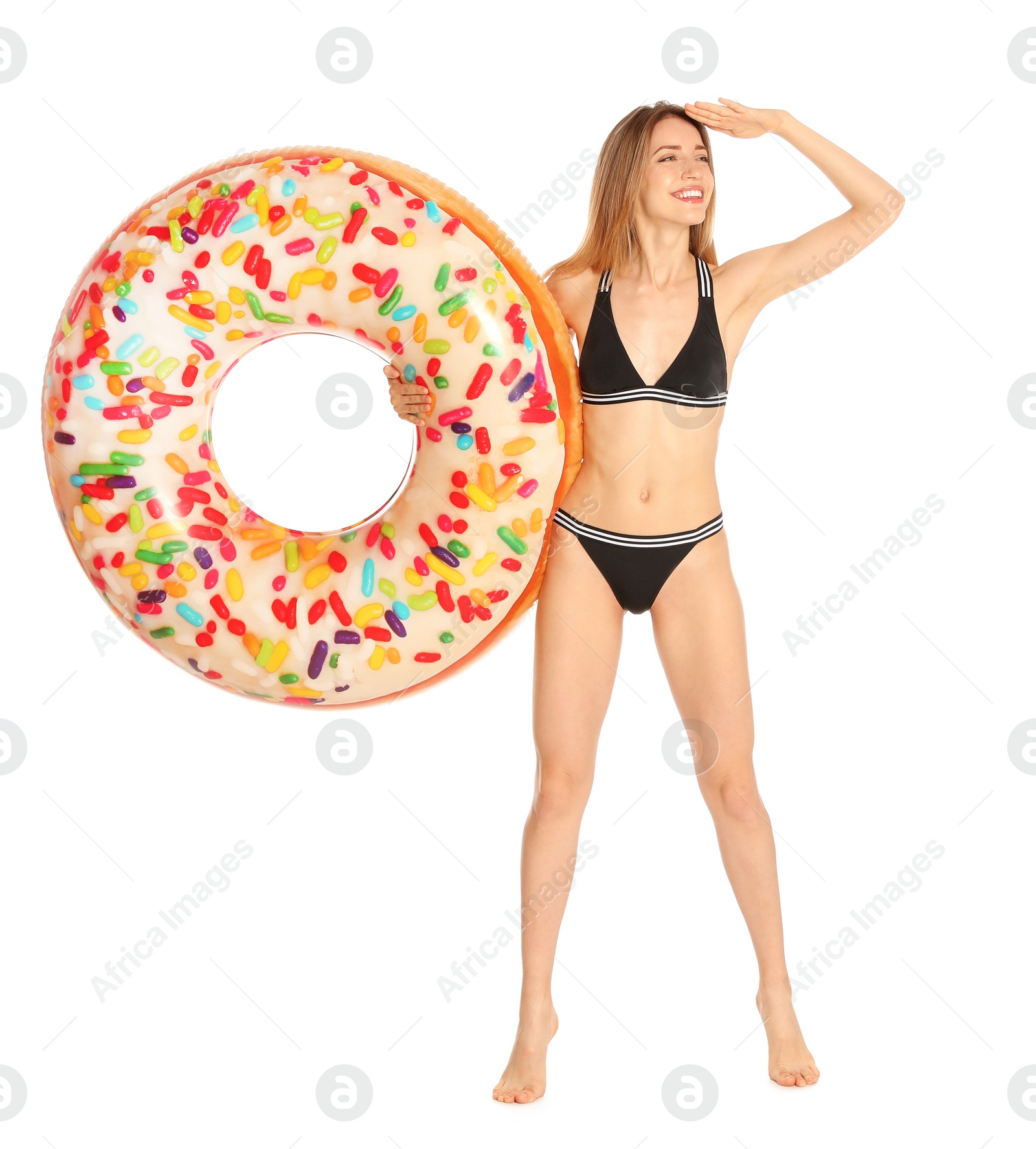 Photo of Beautiful young woman in stylish bikini with doughnut inflatable ring on white background