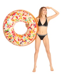 Photo of Beautiful young woman in stylish bikini with doughnut inflatable ring on white background