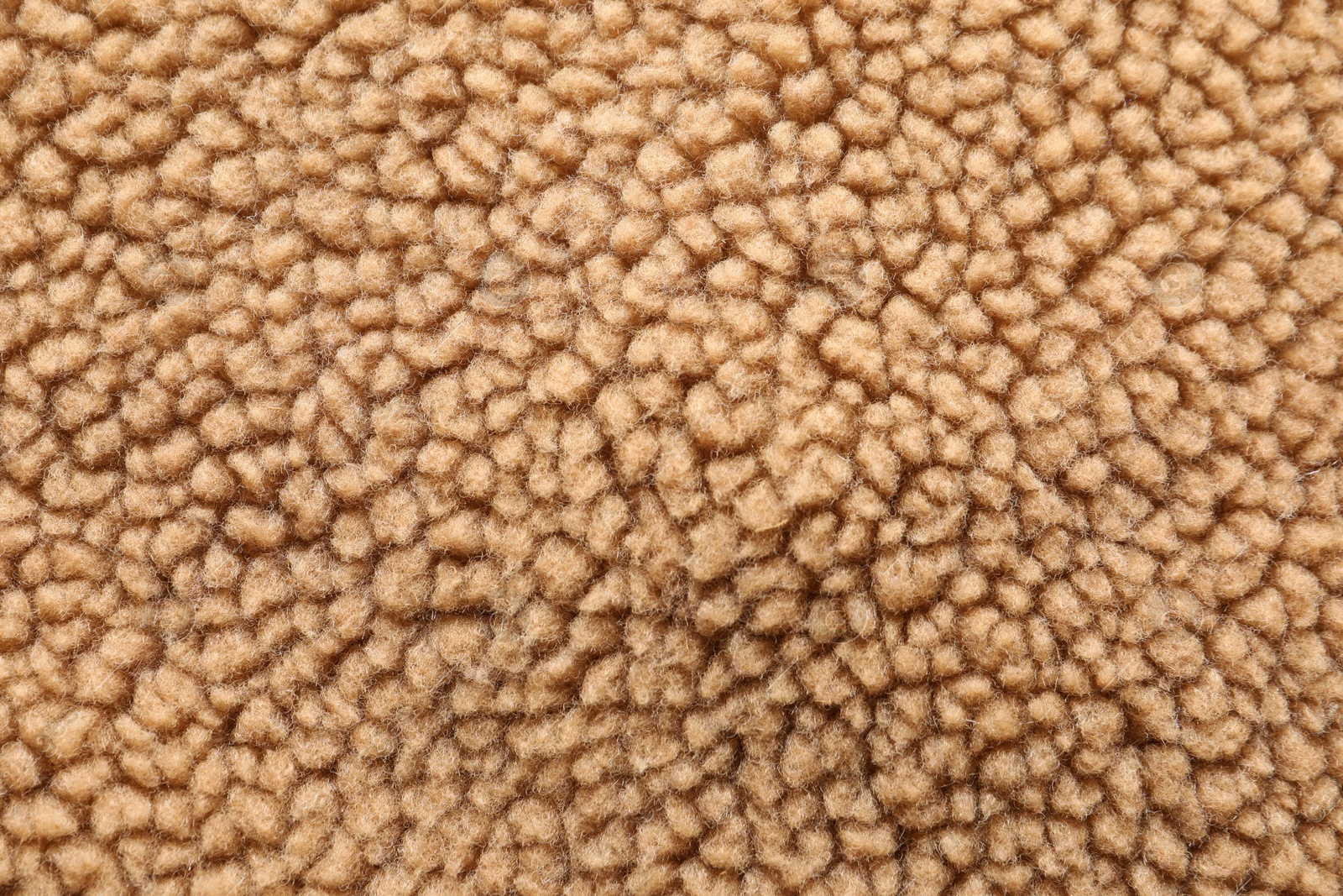 Photo of Texture of light brown faux fur as background, top view