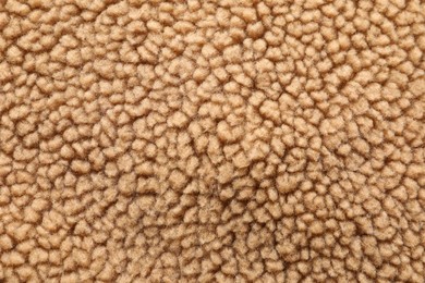 Photo of Texture of light brown faux fur as background, top view