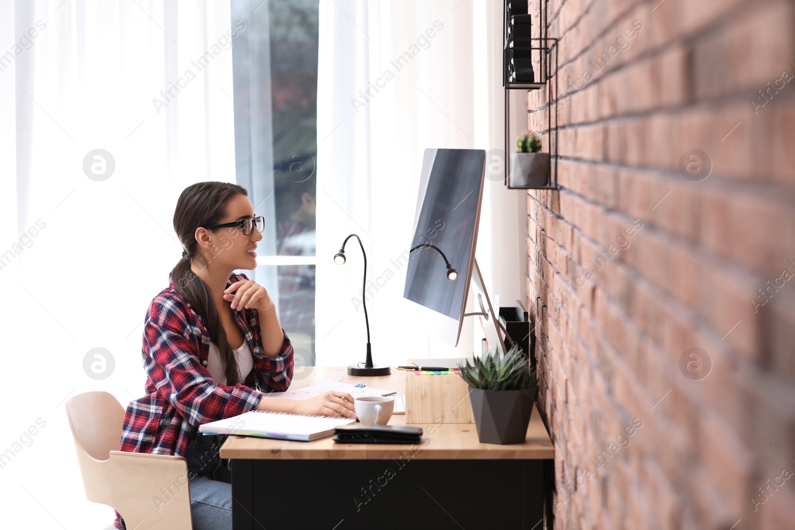 Photo of Professional journalist working with computer in office