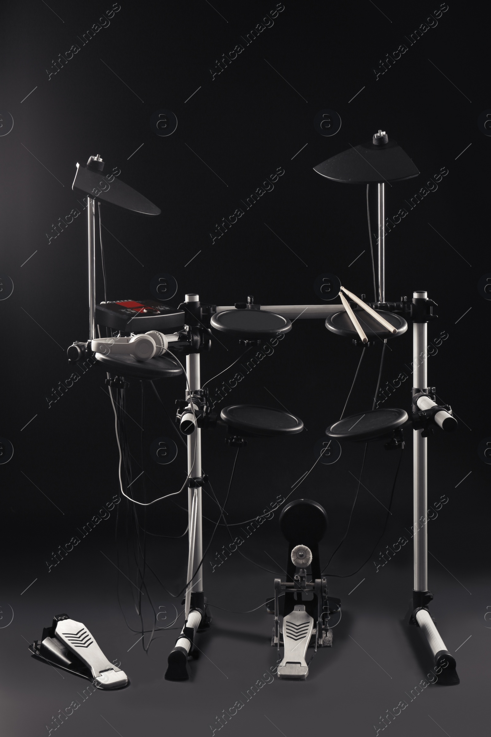 Photo of Modern electronic drum kit on dark background. Musical instrument