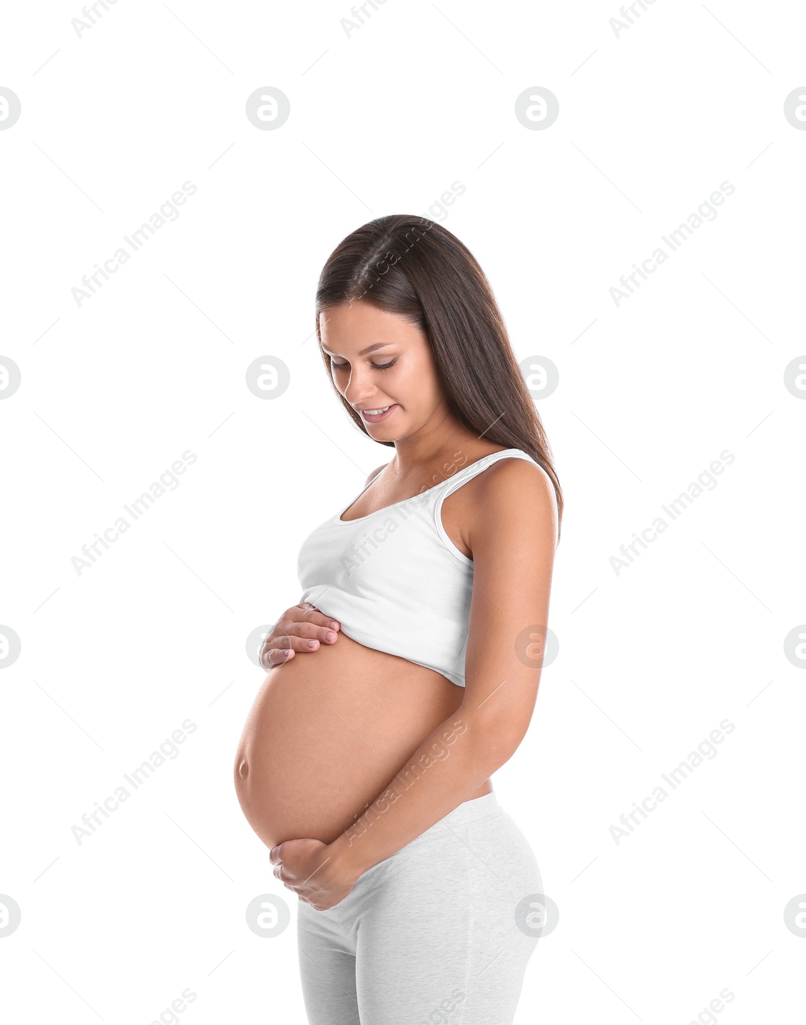 Photo of Happy pregnant woman posing on white background