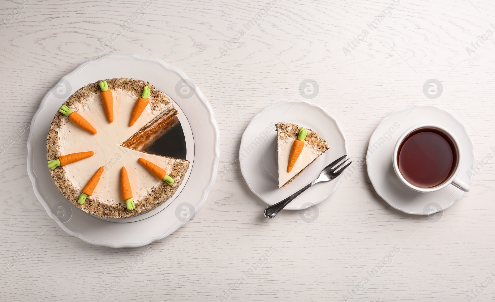 Photo of Flat lay composition with sweet carrot cake on white wooden table