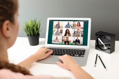 Image of Woman having video chat with colleagues at table in office, closeup. Team work 