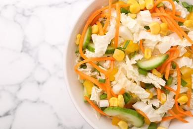 Photo of Tasty salad with Chinese cabbage, carrot, corn and cucumber in bowl on white marble table, top view. Space for text