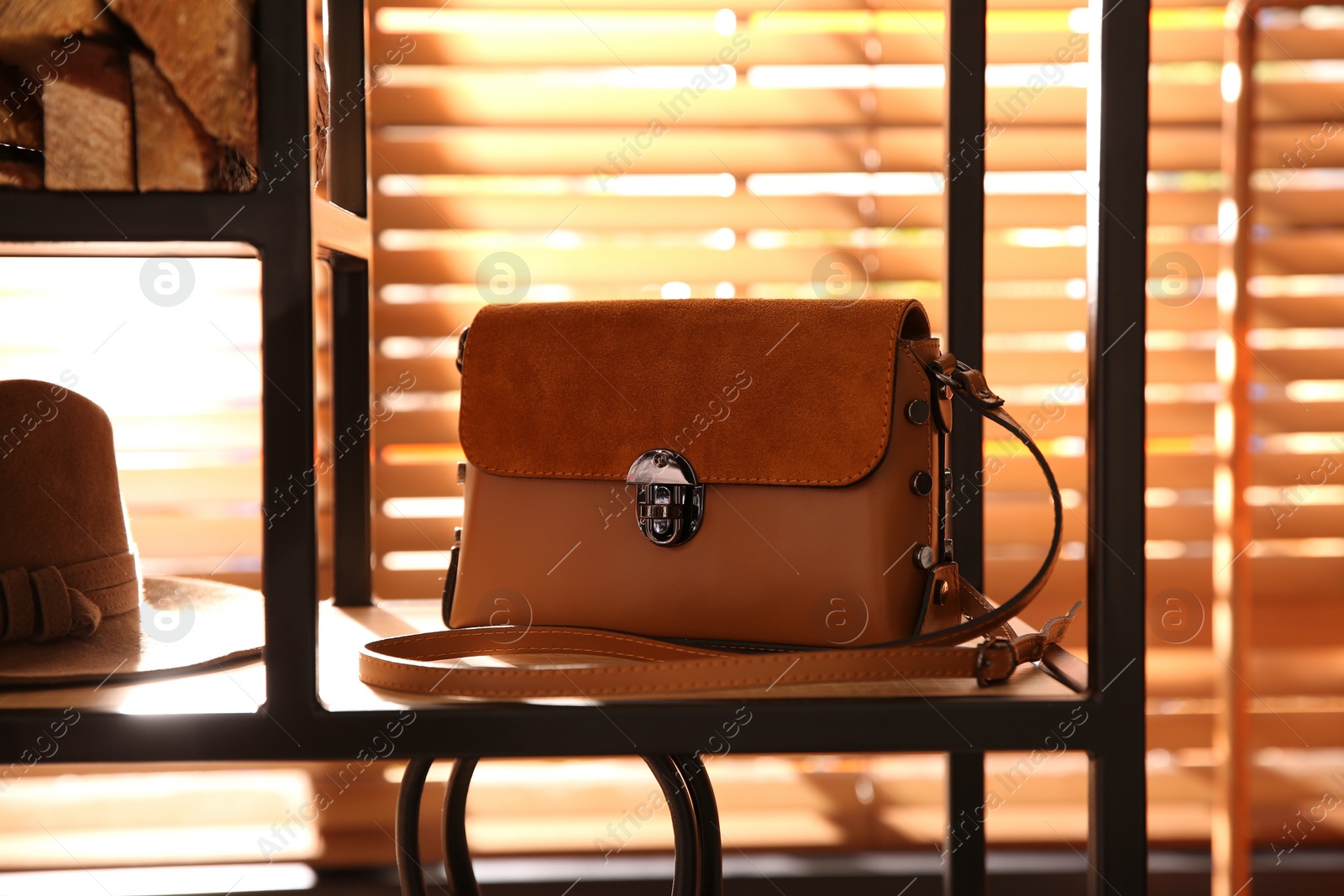 Photo of Stylish woman's bag on shelf in boutique