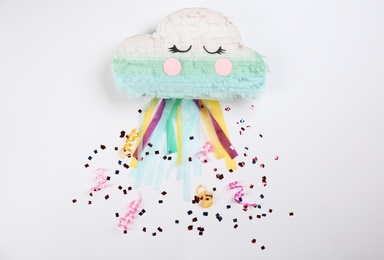 Photo of Cloud shaped pinata, streamers and glitter on white background, top view
