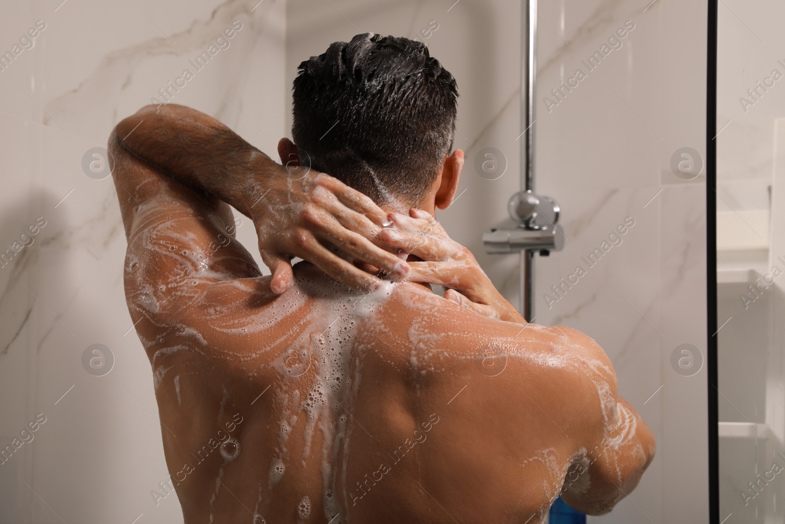 Photo of Man taking shower with gel at home