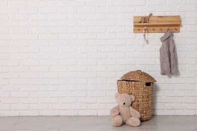 Photo of Beautiful children's room with white brick wall and toys, space for text. Interior design