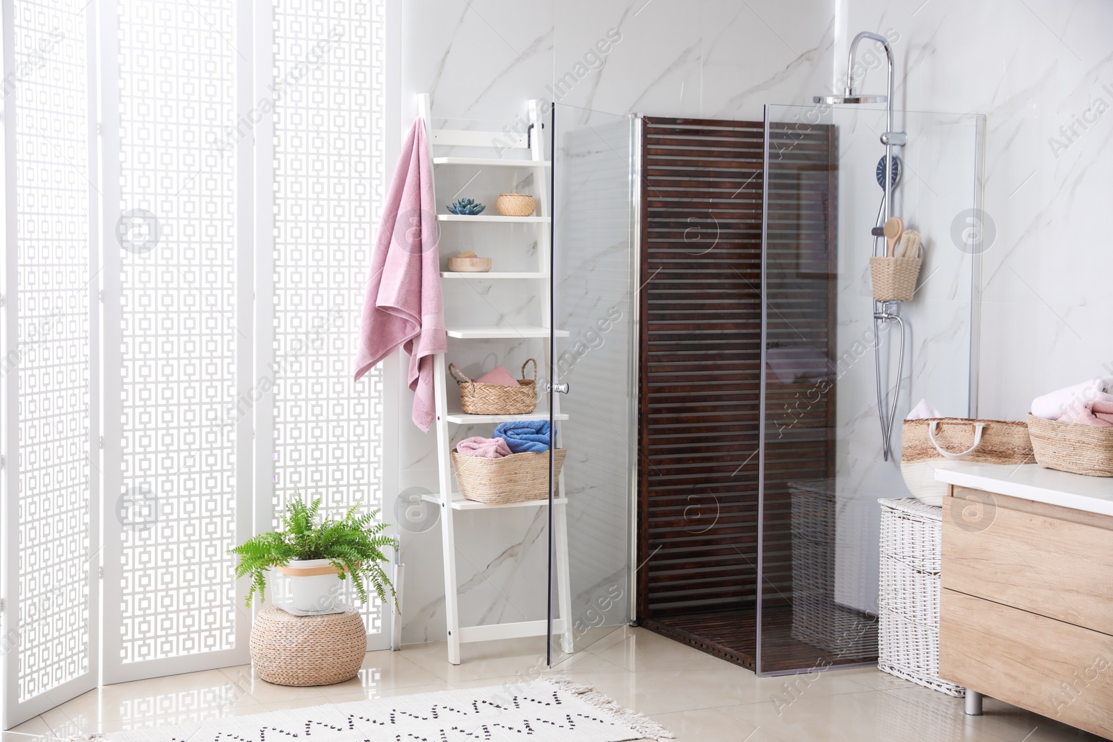 Photo of Bathroom interior with shower stall and shelving unit. Idea for design