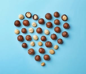 Flat lay composition with organic Macadamia nuts on color background