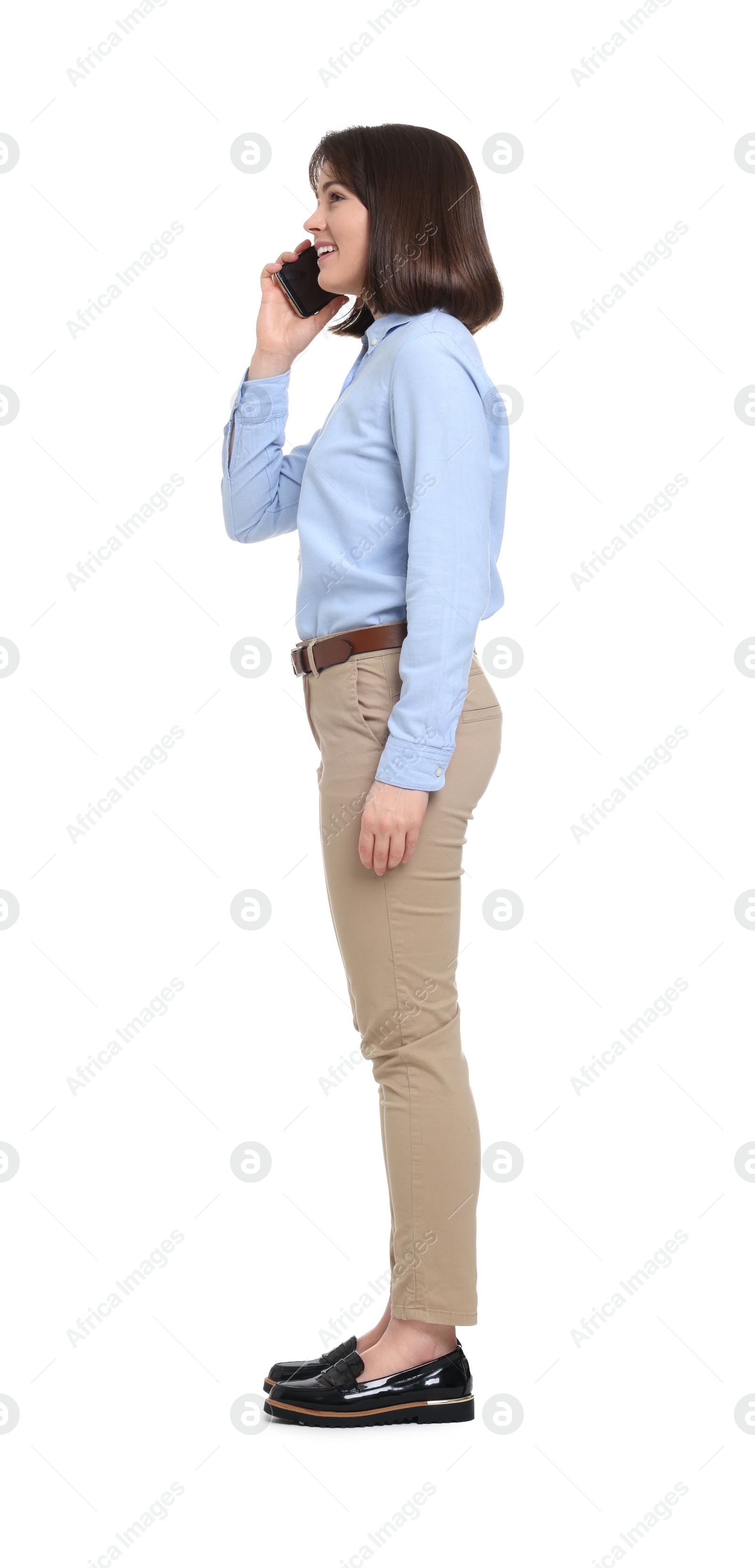 Photo of Happy businesswoman woman talking on smartphone against white background
