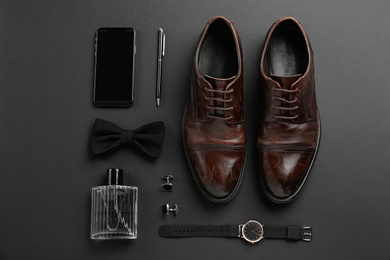 Flat lay composition with male accessories on black background