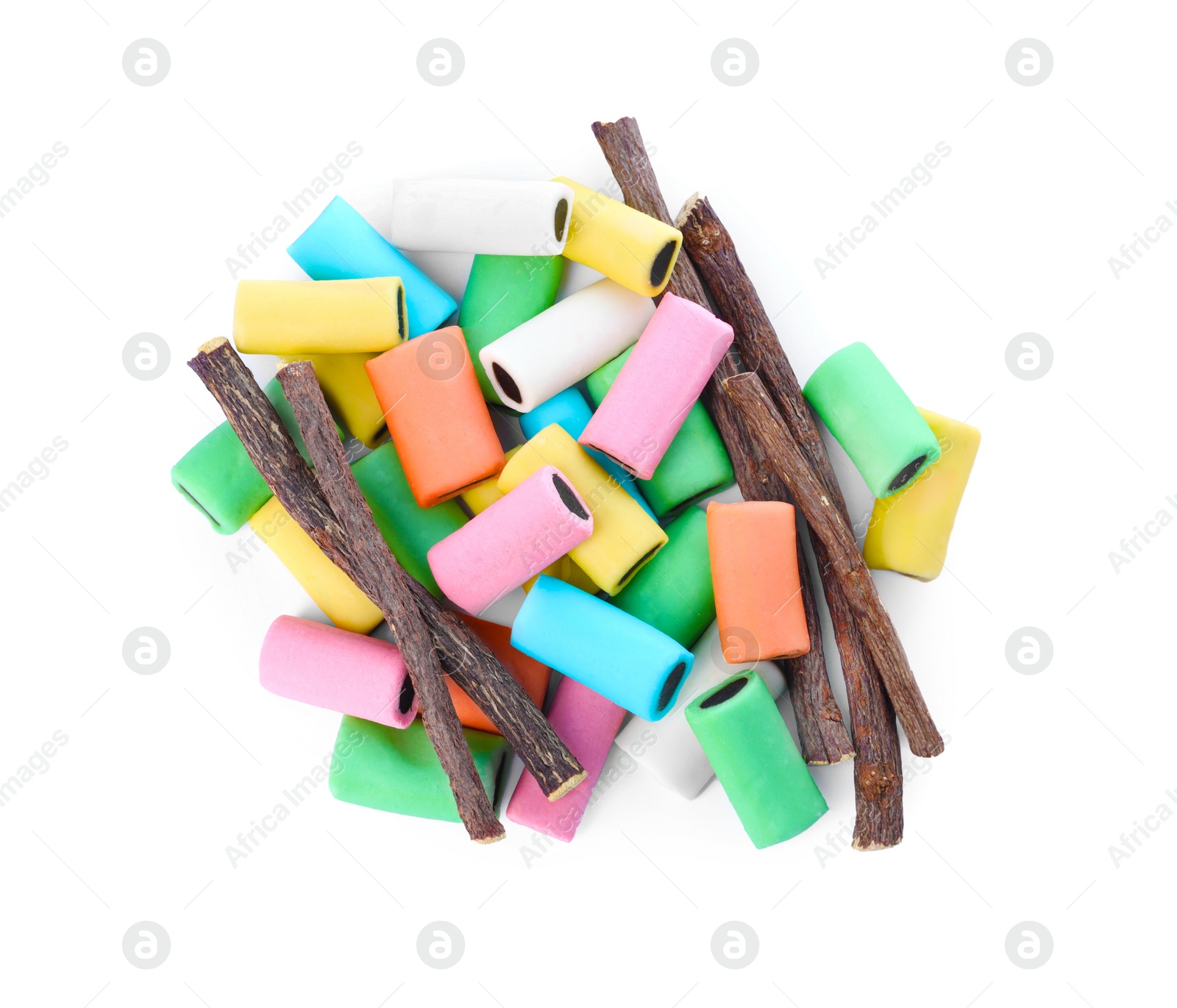 Photo of Many tasty candies and dried sticks of liquorice root isolated on white, top view