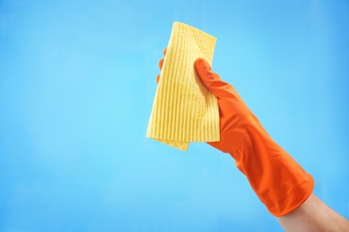 Photo of Woman cleaning glass against color background