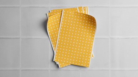 Pepper plasters on white tiled table, top view